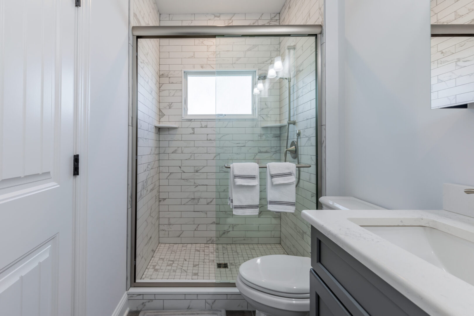 a bathroom with a shower area and a commode